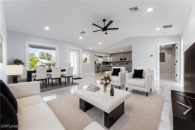 living room featuring ceiling fan and vaulted ceiling