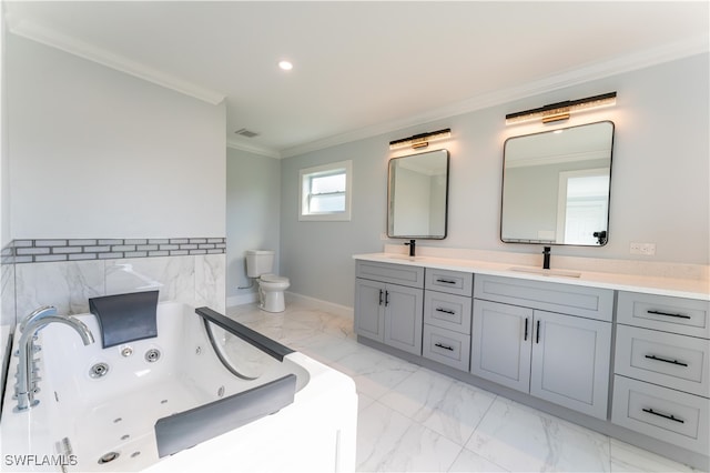 bathroom featuring a tub, toilet, vanity, and ornamental molding