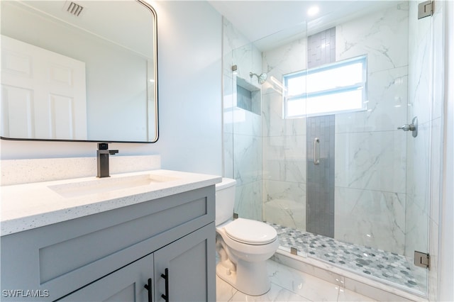 bathroom featuring an enclosed shower, vanity, and toilet