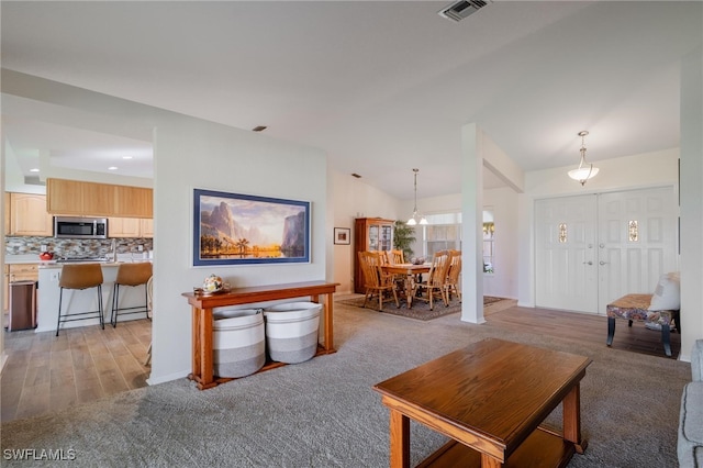 living room featuring light hardwood / wood-style floors and lofted ceiling