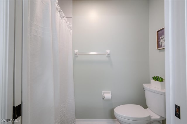 bathroom with toilet and walk in shower