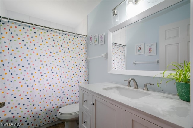 bathroom featuring vanity, curtained shower, and toilet