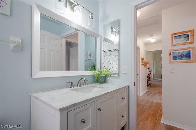 bathroom with vanity and hardwood / wood-style flooring