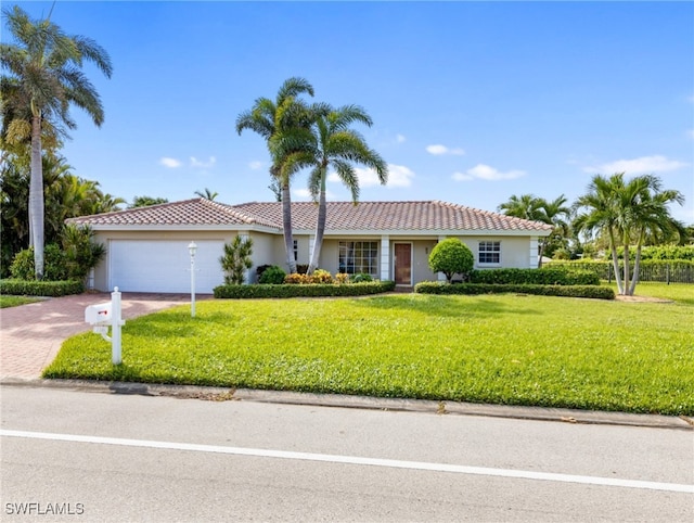 view of front of home with a garage and a front lawn