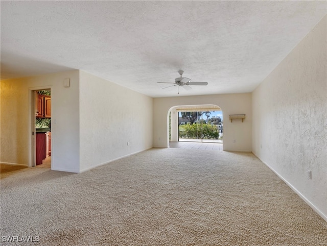 empty room featuring carpet, a textured ceiling, and ceiling fan