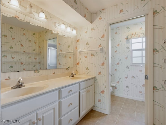 bathroom featuring walk in shower, vanity, toilet, and tile patterned floors