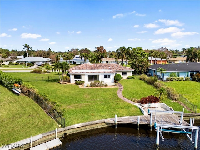 back of property with a yard and a water view