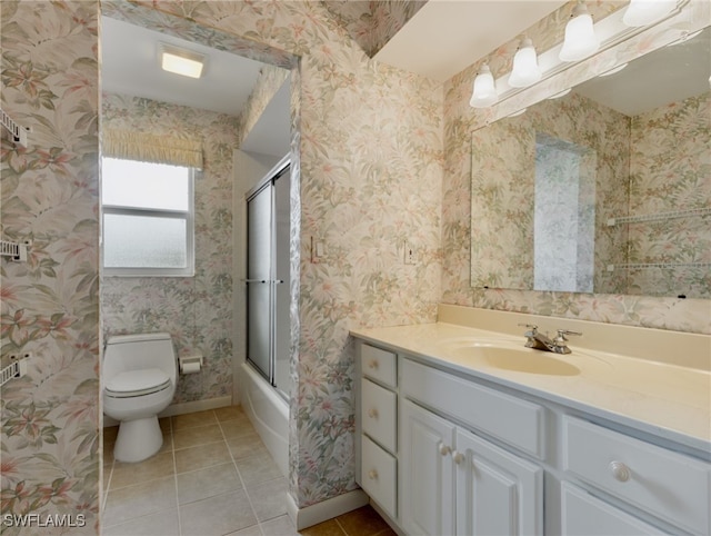 full bathroom with toilet, bath / shower combo with glass door, vanity, and tile patterned flooring