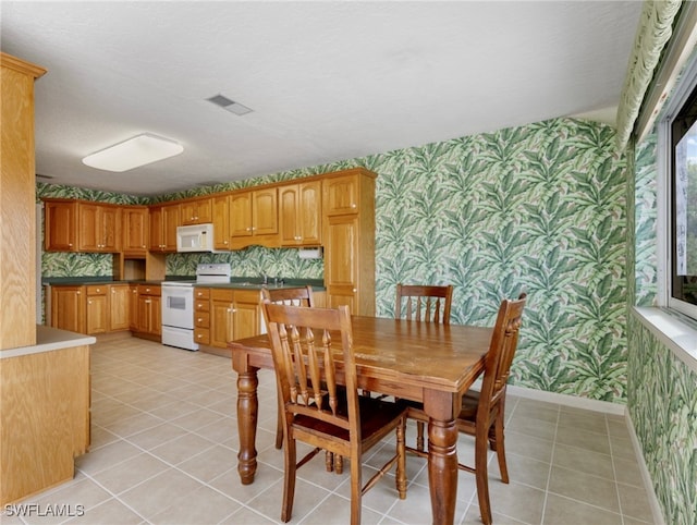 dining room with sink and light tile patterned floors