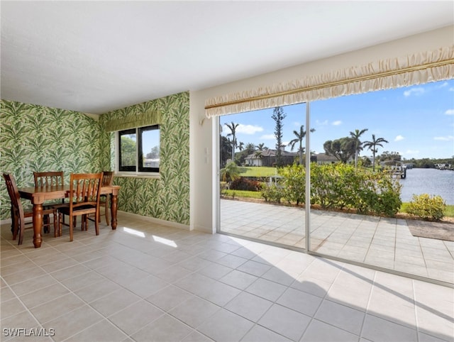 interior space with a water view and plenty of natural light