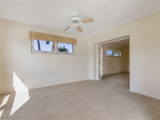 carpeted empty room with ceiling fan