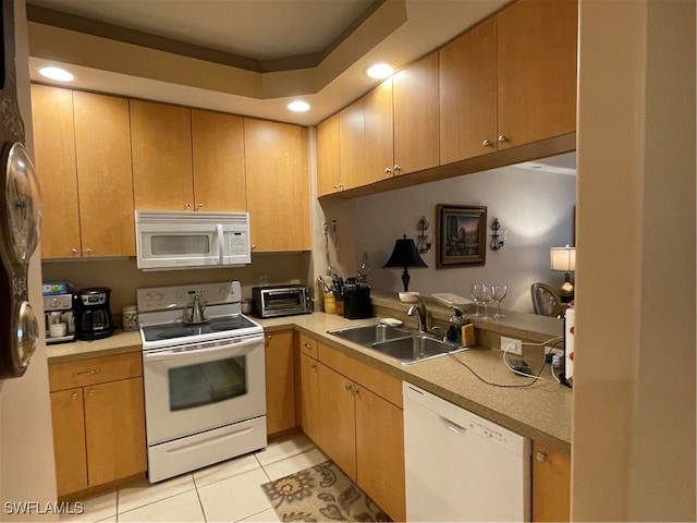 kitchen with sink, white appliances, and light tile patterned floors