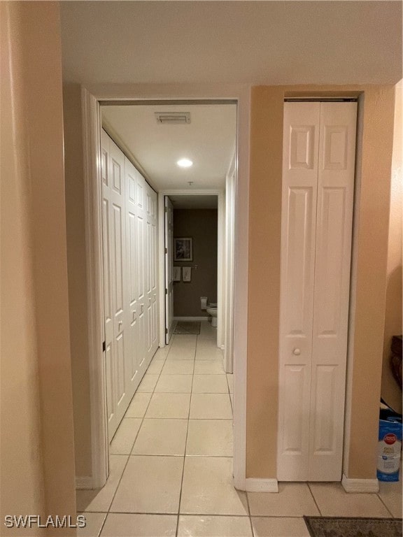 corridor with light tile patterned flooring