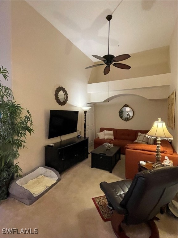 carpeted living room featuring ceiling fan and high vaulted ceiling