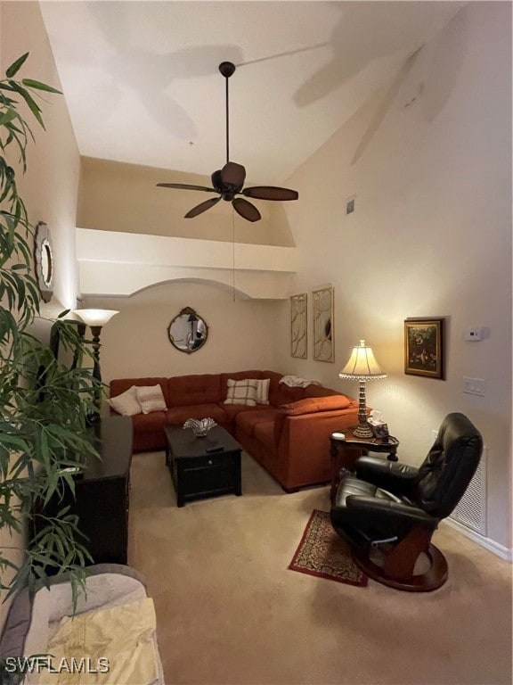 living room with vaulted ceiling, carpet, and ceiling fan