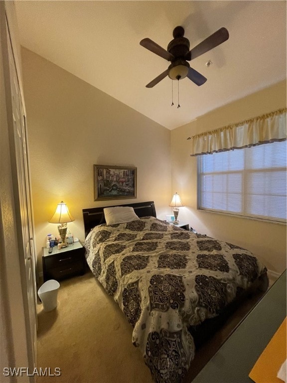 bedroom featuring ceiling fan, carpet flooring, and lofted ceiling