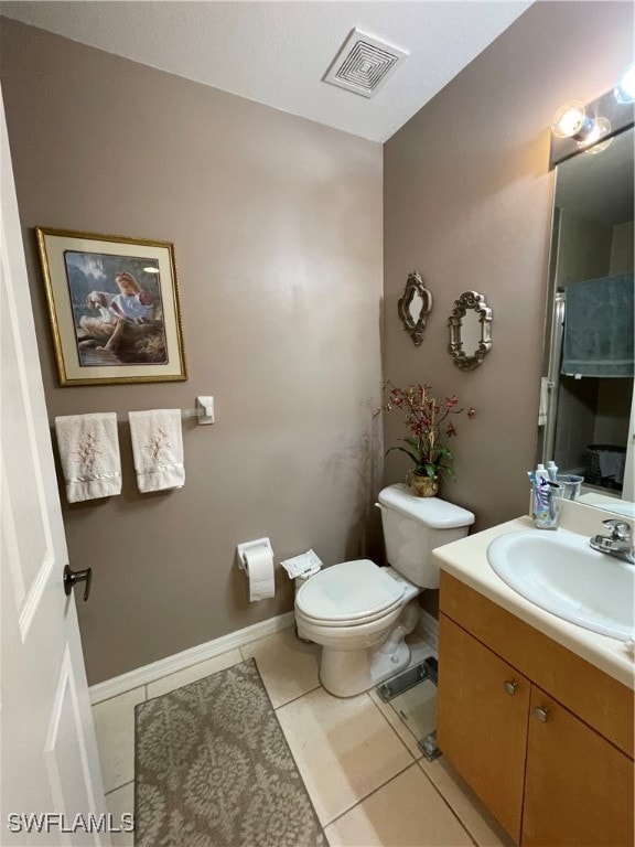 bathroom featuring vanity, toilet, and tile patterned floors