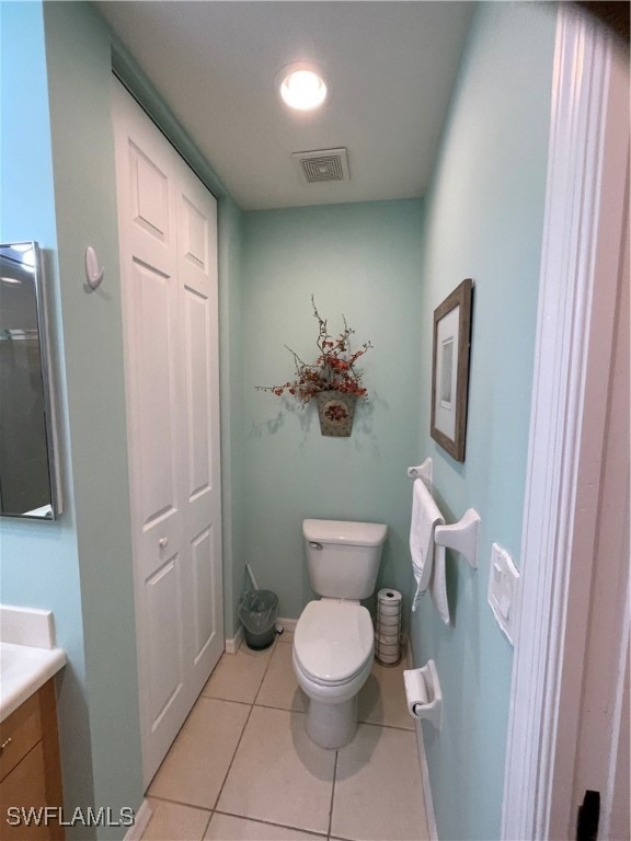 bathroom with vanity, toilet, and tile patterned flooring