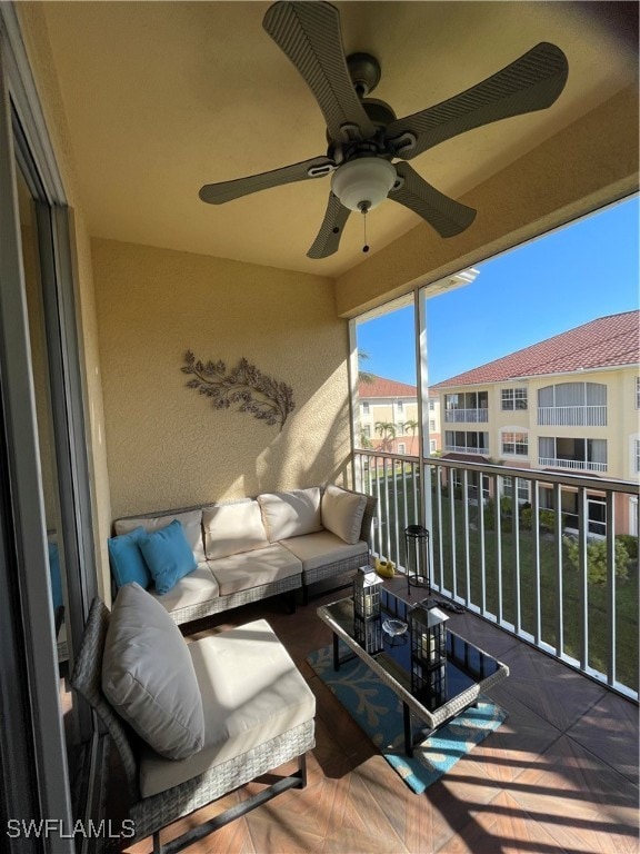 balcony with an outdoor living space and ceiling fan