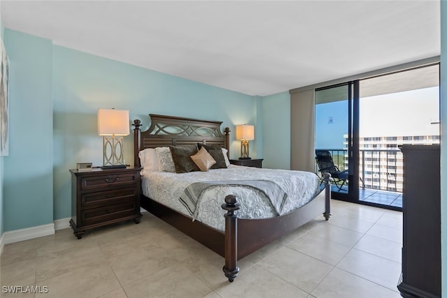 bedroom with access to outside, light tile patterned floors, and expansive windows