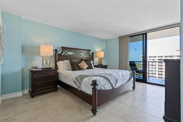380 Seaview Ct Unit 1808, Marco Island, FL 34145 - bedroom with access to outside, a wall of windows, light tile patterned floors, and baseboards