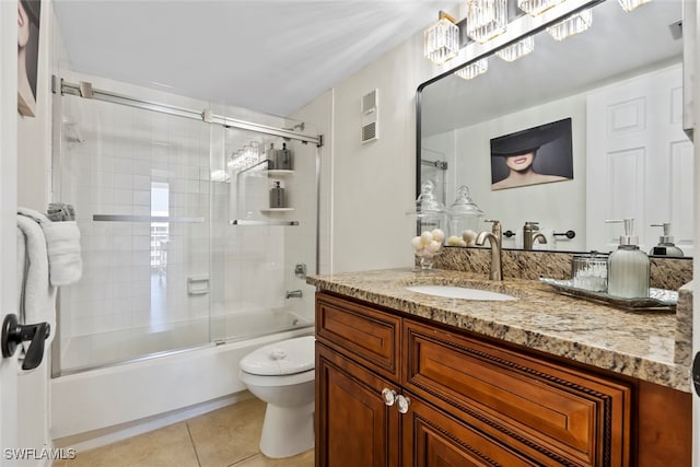 full bathroom featuring toilet, vanity, shower / bath combination with glass door, and tile patterned flooring