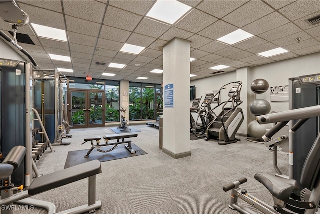 workout area with a drop ceiling, french doors, and carpet