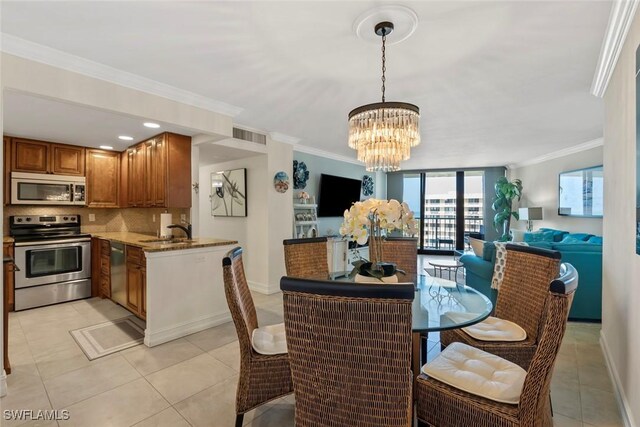 380 Seaview Ct Unit 1808, Marco Island, FL 34145 - dining space with a chandelier, ornamental molding, light tile patterned flooring, and baseboards