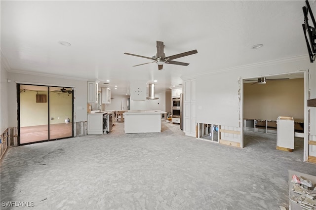 unfurnished living room featuring light carpet, ornamental molding, sink, and ceiling fan