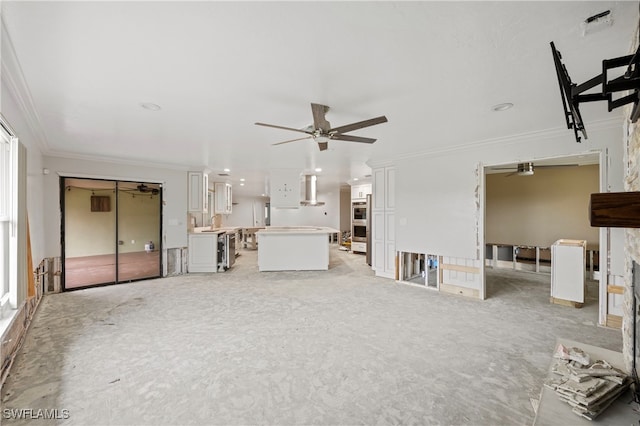 unfurnished living room with crown molding and ceiling fan