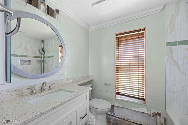 bathroom featuring vanity, ornamental molding, toilet, and a tile shower