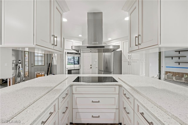 kitchen with white cabinetry, appliances with stainless steel finishes, and exhaust hood