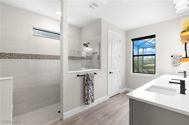 bathroom with vanity and tiled shower