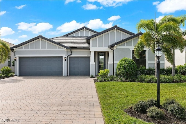 view of front of house with a front yard and a garage