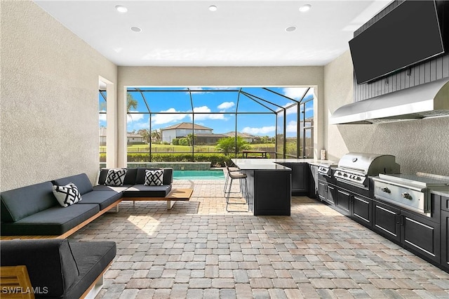 view of patio / terrace featuring an outdoor living space, an outdoor kitchen, an outdoor bar, a lanai, and area for grilling