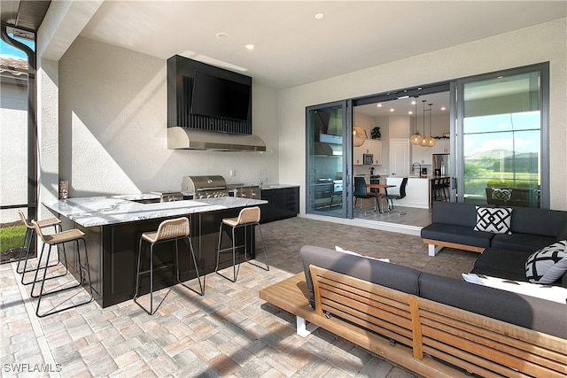 view of patio featuring area for grilling, an outdoor living space, and exterior bar