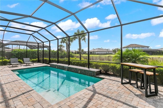 view of swimming pool with a lanai and a patio area