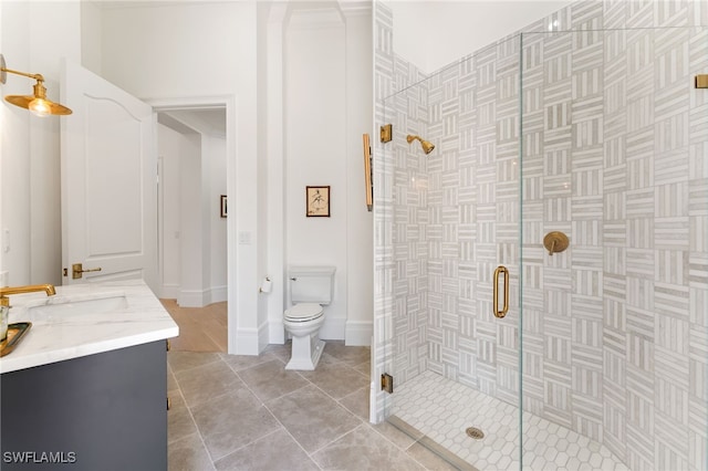 bathroom featuring tile patterned flooring, vanity, toilet, and a shower with door