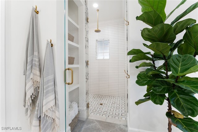 bathroom with tile patterned floors and a shower with shower door