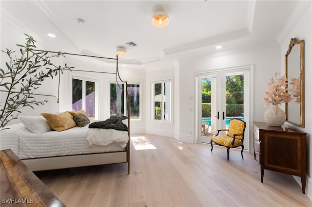 bedroom with light wood-type flooring, ornamental molding, access to outside, and french doors