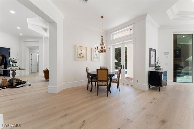 dining room with crown molding and light wood-type flooring