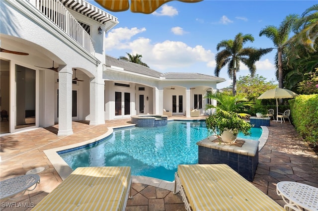 view of swimming pool featuring an in ground hot tub, french doors, ceiling fan, and a patio area