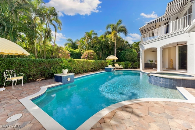 view of pool featuring a patio area and an in ground hot tub