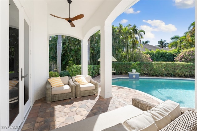 view of swimming pool with ceiling fan and a patio area