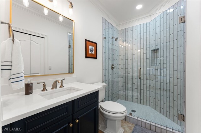 bathroom featuring vanity, toilet, an enclosed shower, and ornamental molding