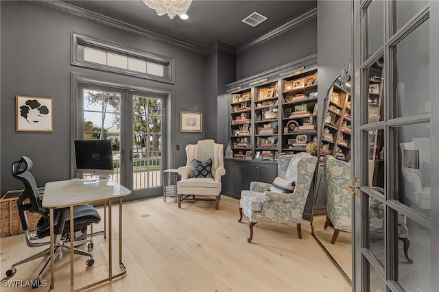 office space with french doors, light wood-type flooring, and ornamental molding