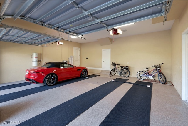 garage featuring water heater and a garage door opener