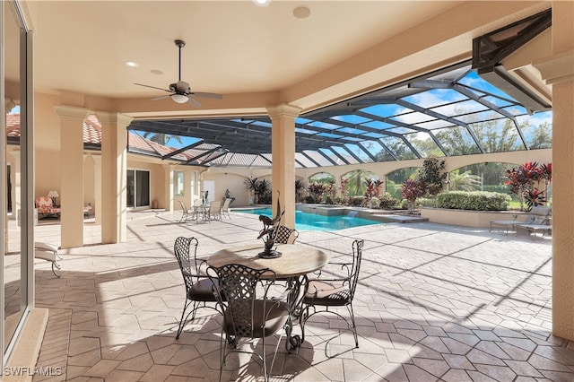 view of patio featuring ceiling fan and a lanai