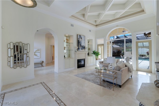 living room with beam ceiling, crown molding, a towering ceiling, and coffered ceiling