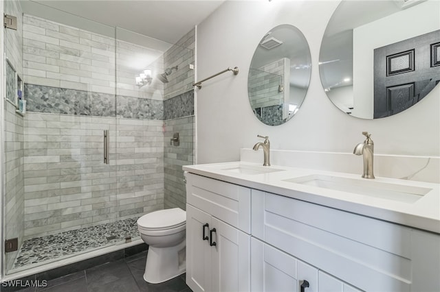 bathroom featuring vanity, tile patterned floors, toilet, and walk in shower